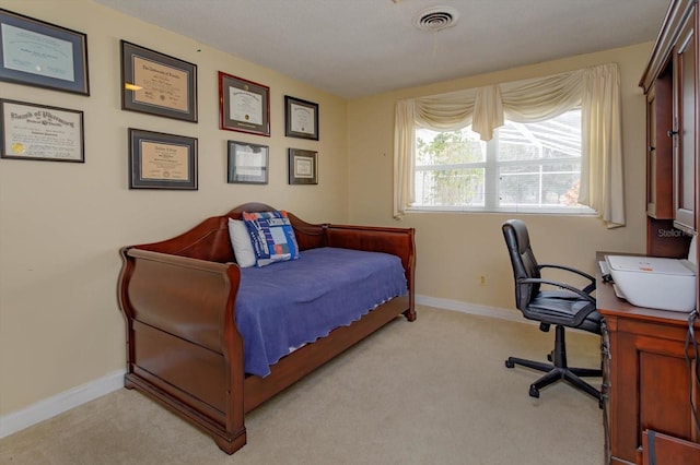 carpeted bedroom with visible vents and baseboards