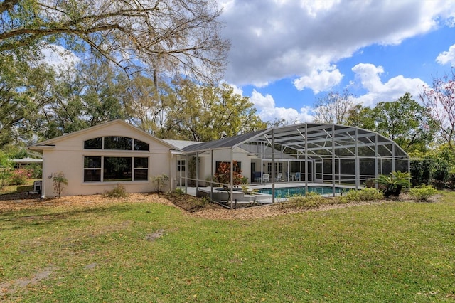 back of house featuring glass enclosure, a lawn, and an outdoor pool