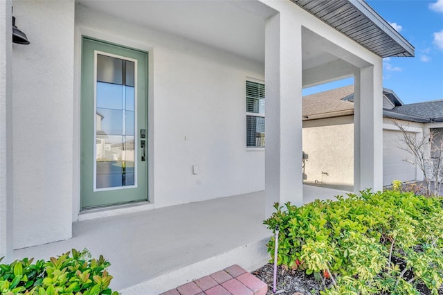 property entrance featuring stucco siding