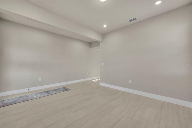 empty room featuring recessed lighting, baseboards, and visible vents