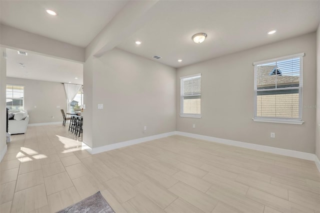 spare room featuring beamed ceiling, recessed lighting, baseboards, and visible vents