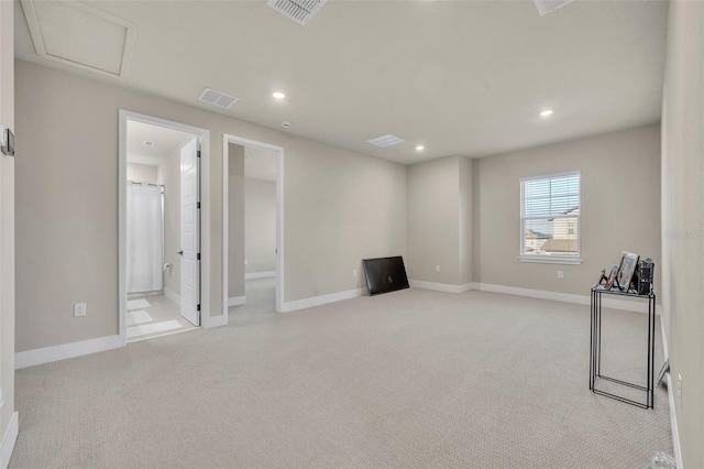 below grade area with light carpet, visible vents, recessed lighting, and baseboards