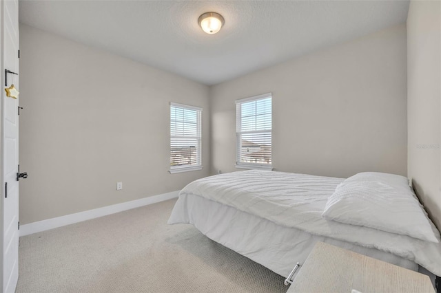 carpeted bedroom with baseboards