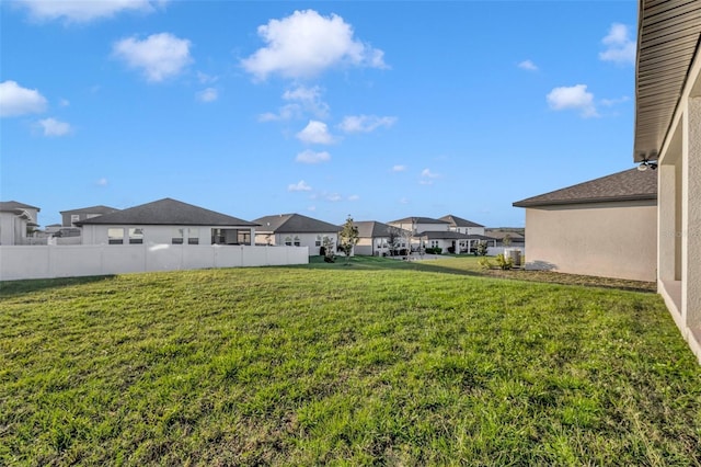 view of yard with a residential view and fence