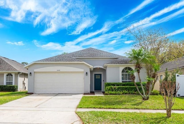 ranch-style home with stucco siding, driveway, an attached garage, and a front lawn