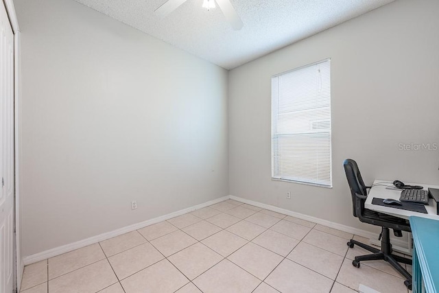 office with ceiling fan, light tile patterned flooring, baseboards, and a textured ceiling