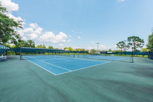 view of sport court featuring fence