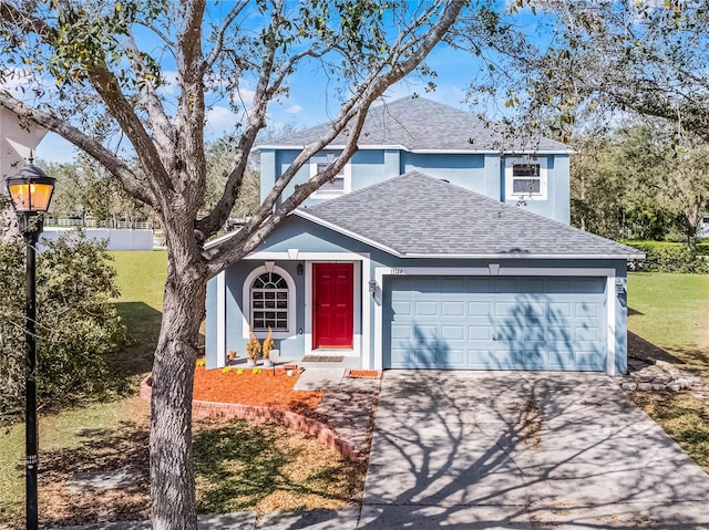 traditional home with driveway, an attached garage, stucco siding, a shingled roof, and a front lawn