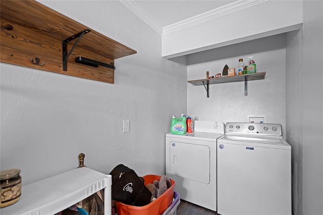 laundry room featuring laundry area, crown molding, a textured wall, and washer and clothes dryer