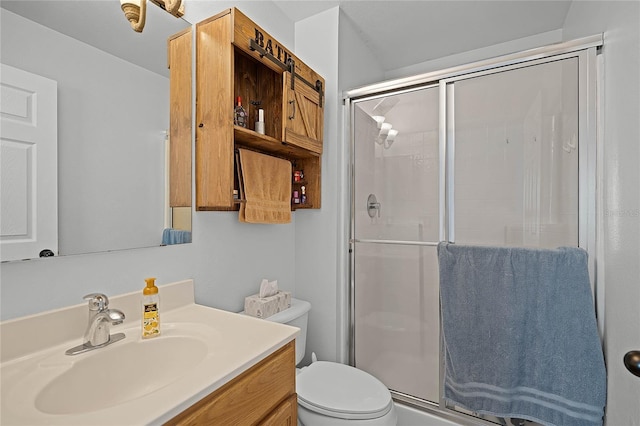 full bathroom featuring toilet, a stall shower, and vanity