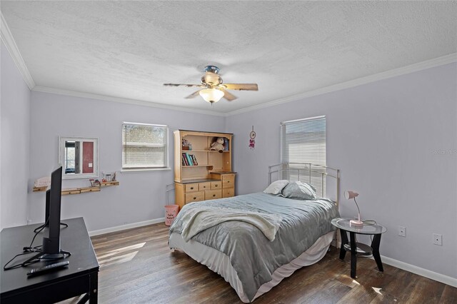 bedroom featuring a textured ceiling, crown molding, baseboards, and wood finished floors