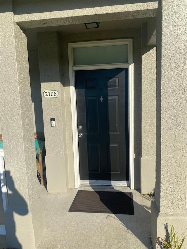 doorway to property with stucco siding
