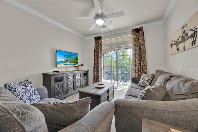 living area featuring visible vents, crown molding, a ceiling fan, and wood finished floors