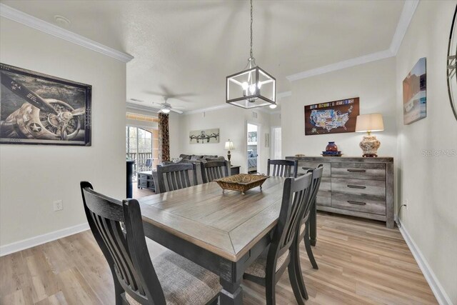 dining room with light wood-style floors, baseboards, and ornamental molding