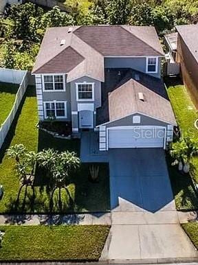 view of front of home featuring fence, a garage, and driveway