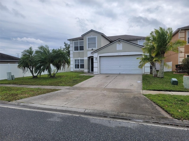 view of front of home with a front lawn, an attached garage, concrete driveway, and stucco siding