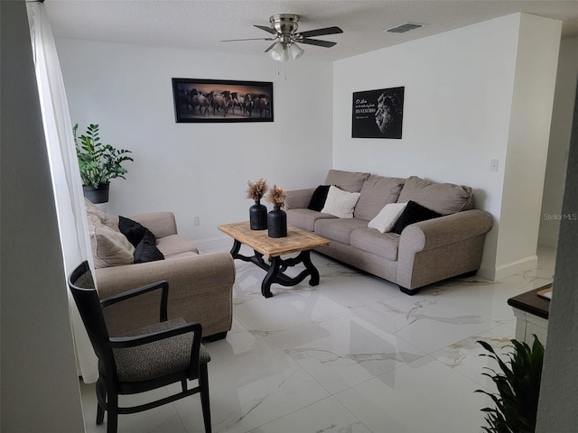 living area featuring baseboards, visible vents, ceiling fan, a textured ceiling, and marble finish floor