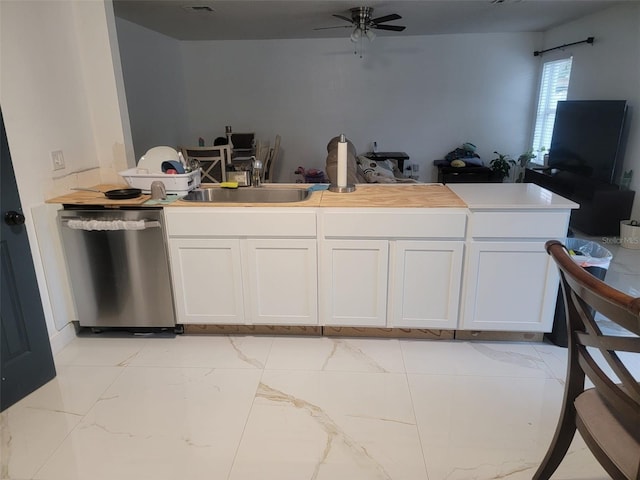 kitchen with white cabinets, dishwasher, marble finish floor, and ceiling fan