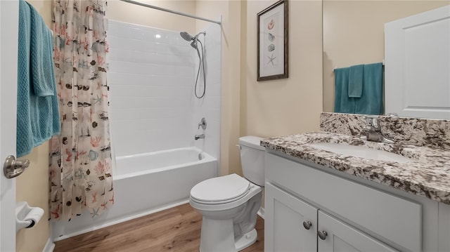 full bathroom with shower / bath combo with shower curtain, toilet, wood finished floors, and vanity