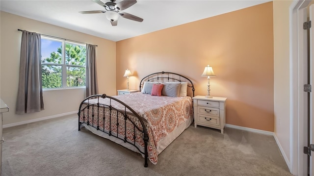 bedroom featuring light colored carpet, baseboards, and ceiling fan