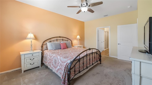 bedroom with a ceiling fan, baseboards, visible vents, and light carpet