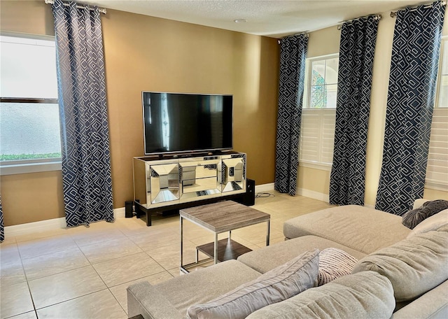 tiled living room featuring a textured ceiling and baseboards