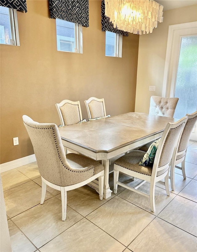 dining area with an inviting chandelier and baseboards