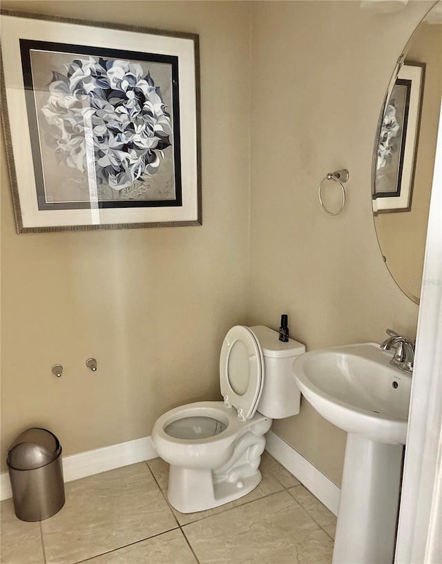 half bathroom with toilet and baseboards