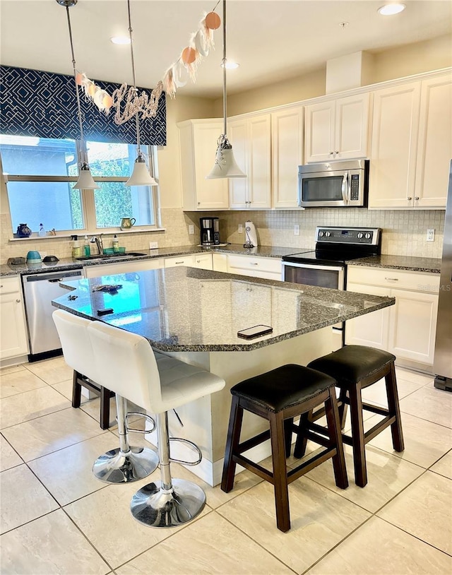 kitchen with a sink, backsplash, and stainless steel appliances