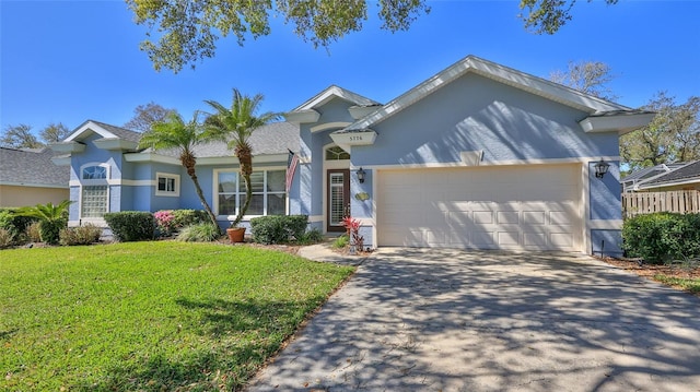 single story home with stucco siding, driveway, a front yard, and an attached garage