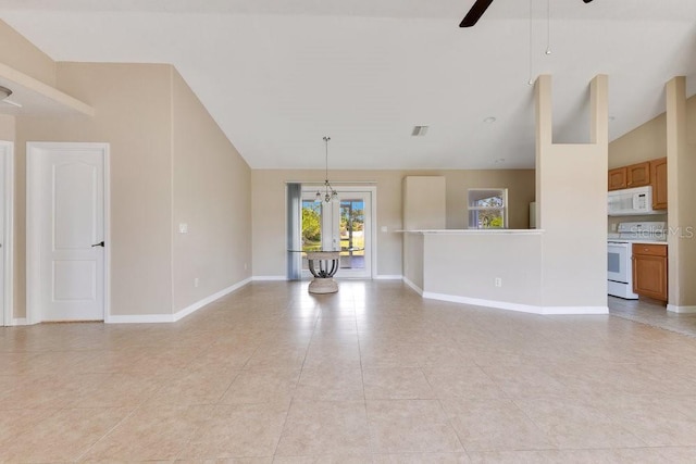 unfurnished living room with light tile patterned floors, a ceiling fan, visible vents, baseboards, and high vaulted ceiling