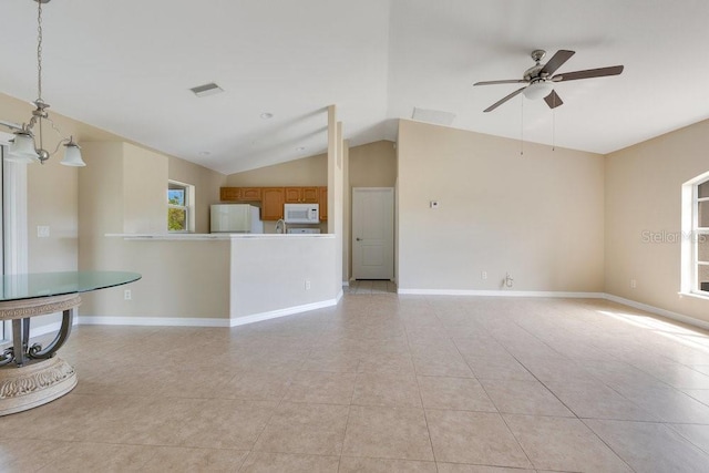 unfurnished living room with vaulted ceiling, light tile patterned floors, baseboards, and visible vents