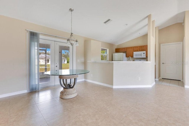 dining room featuring visible vents, lofted ceiling, baseboards, and french doors