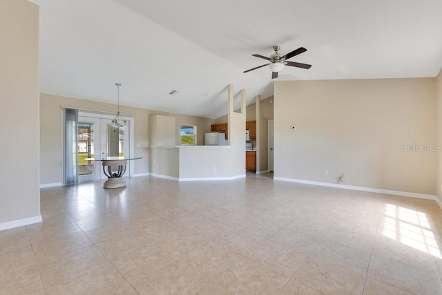 unfurnished living room with light tile patterned floors, high vaulted ceiling, baseboards, and a ceiling fan