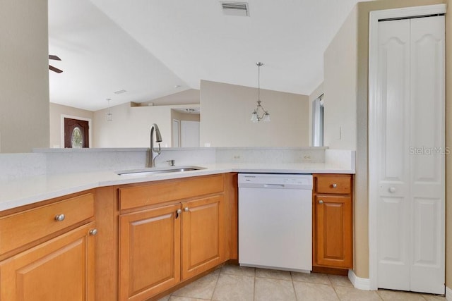 kitchen with visible vents, a sink, light countertops, dishwasher, and vaulted ceiling