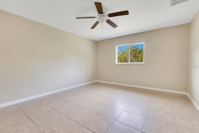 spare room with light tile patterned floors, baseboards, visible vents, and ceiling fan