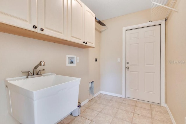 clothes washing area with electric dryer hookup, washer hookup, a sink, cabinet space, and baseboards