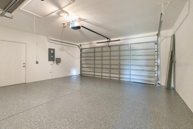 garage featuring electric panel and a garage door opener