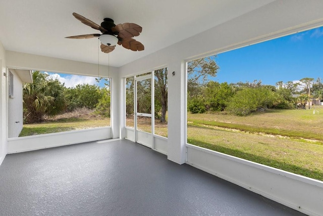 unfurnished sunroom featuring ceiling fan