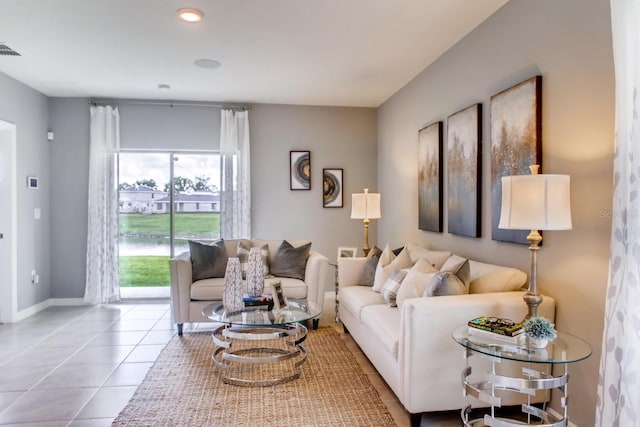 living room featuring tile patterned flooring, visible vents, and baseboards