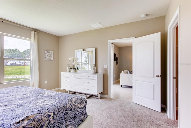 bedroom with light tile patterned floors, baseboards, light carpet, and visible vents