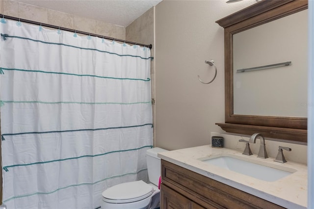 full bathroom with curtained shower, a textured ceiling, toilet, and vanity