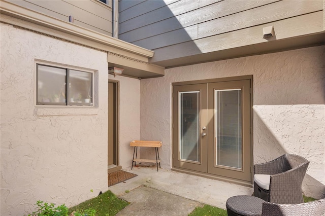 property entrance with a patio area and stucco siding