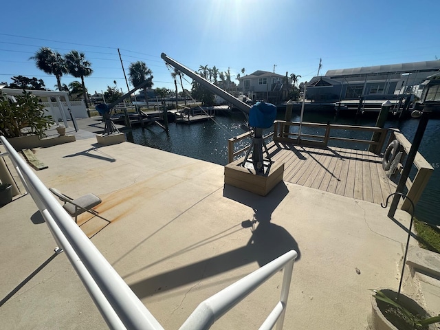 view of dock with boat lift and a water view