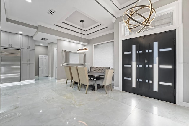 dining room with visible vents, marble finish floor, crown molding, and a tray ceiling