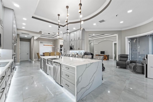 kitchen with visible vents, a sink, marble finish floor, a raised ceiling, and open floor plan