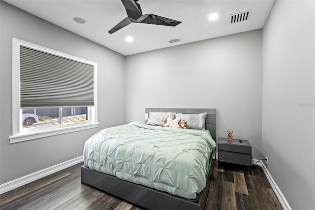 bedroom featuring visible vents, baseboards, and wood finished floors