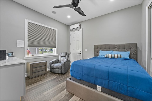 bedroom with recessed lighting, light wood-style flooring, an AC wall unit, and a ceiling fan