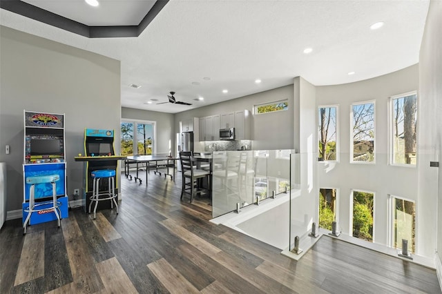 interior space featuring recessed lighting, ceiling fan, baseboards, and wood finished floors