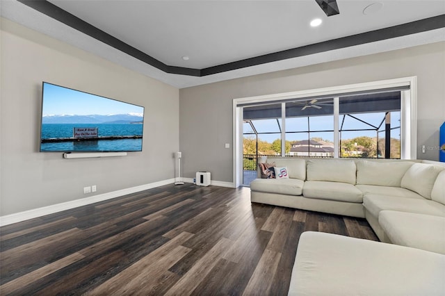 unfurnished living room featuring baseboards, dark wood finished floors, recessed lighting, a sunroom, and ceiling fan